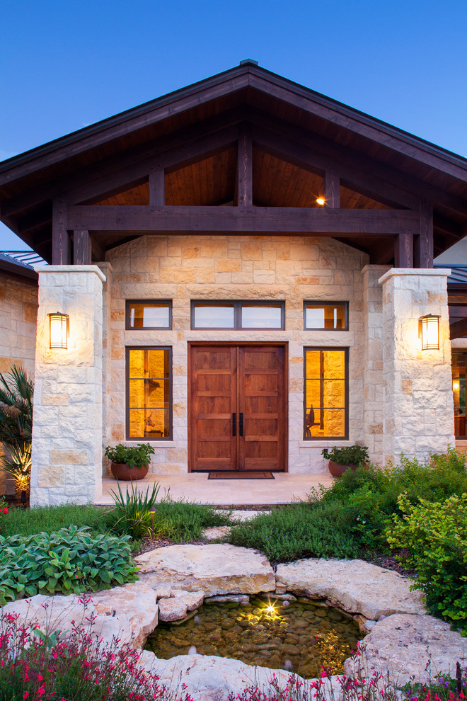 Country front door in Austin with a double front door and a medium wood front door.