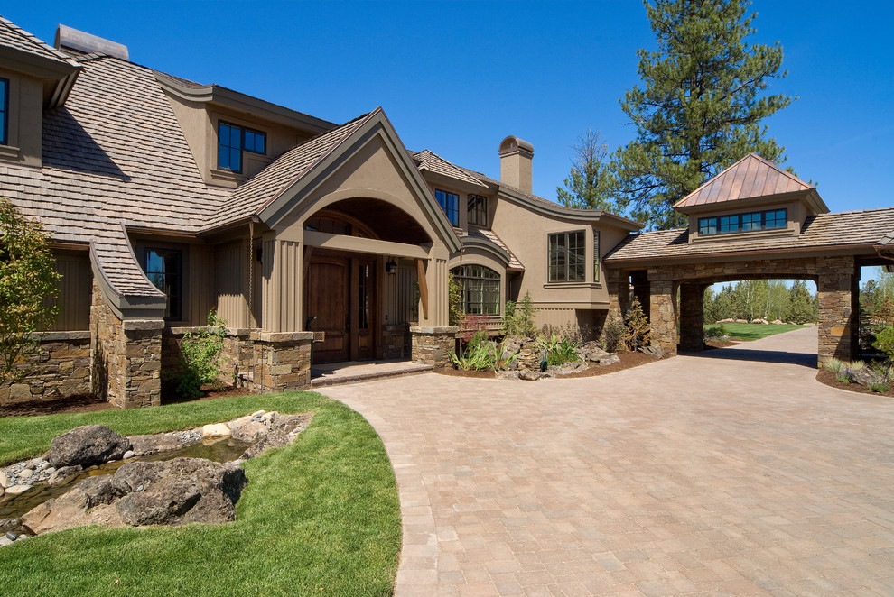 Mountain style two-story stone exterior home photo