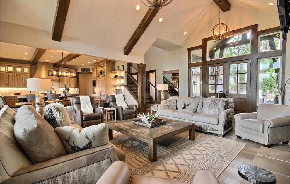 Design ideas for an expansive classic open plan living room in Portland with multi-coloured walls, dark hardwood flooring, a standard fireplace, a stone fireplace surround, a wall mounted tv, brown floors and a vaulted ceiling.