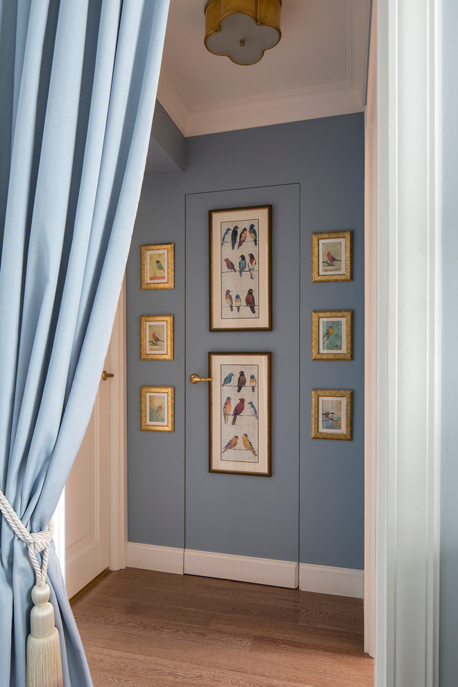 Inspiration for a traditional hallway in Moscow with blue walls and dark hardwood floors.