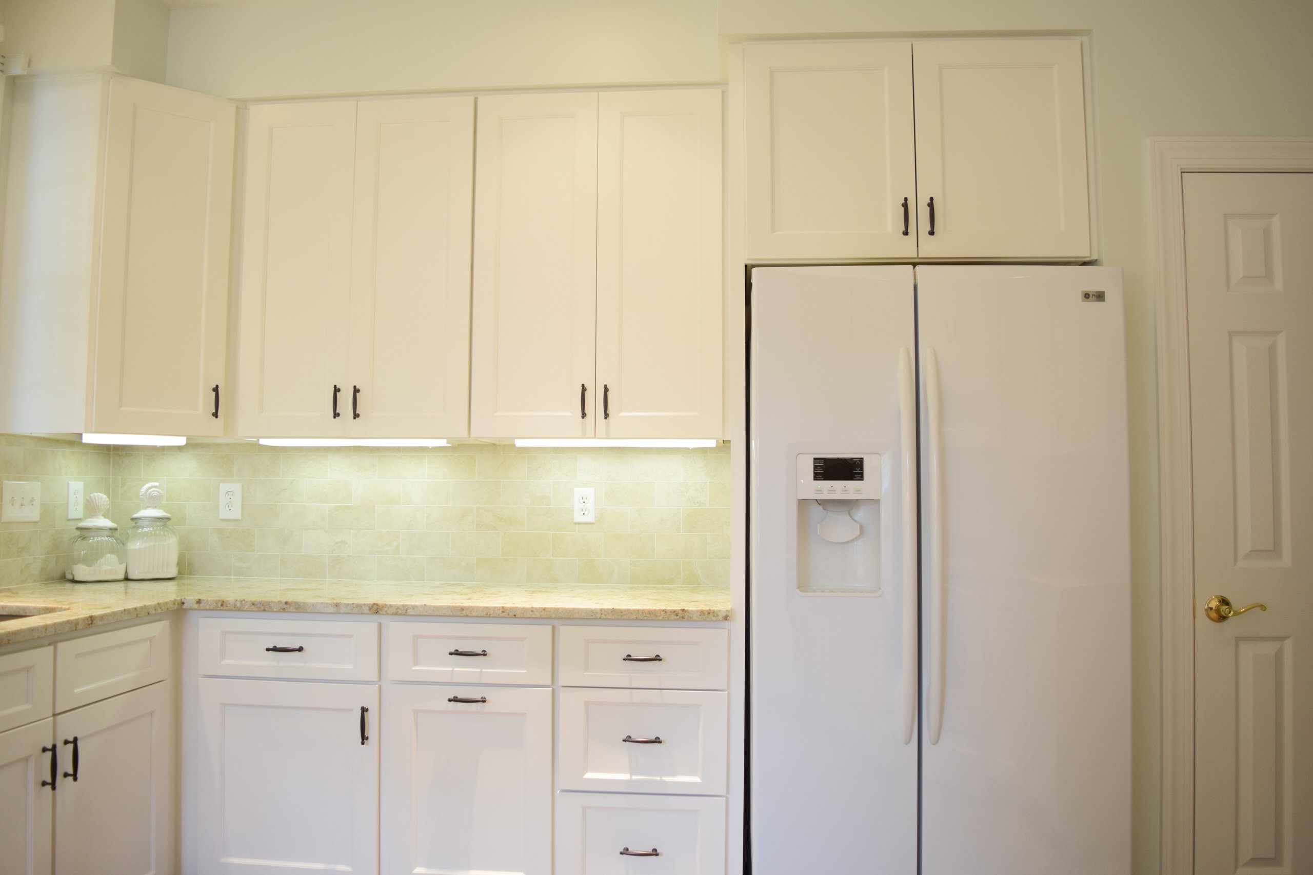 White appliances with white cabinets.