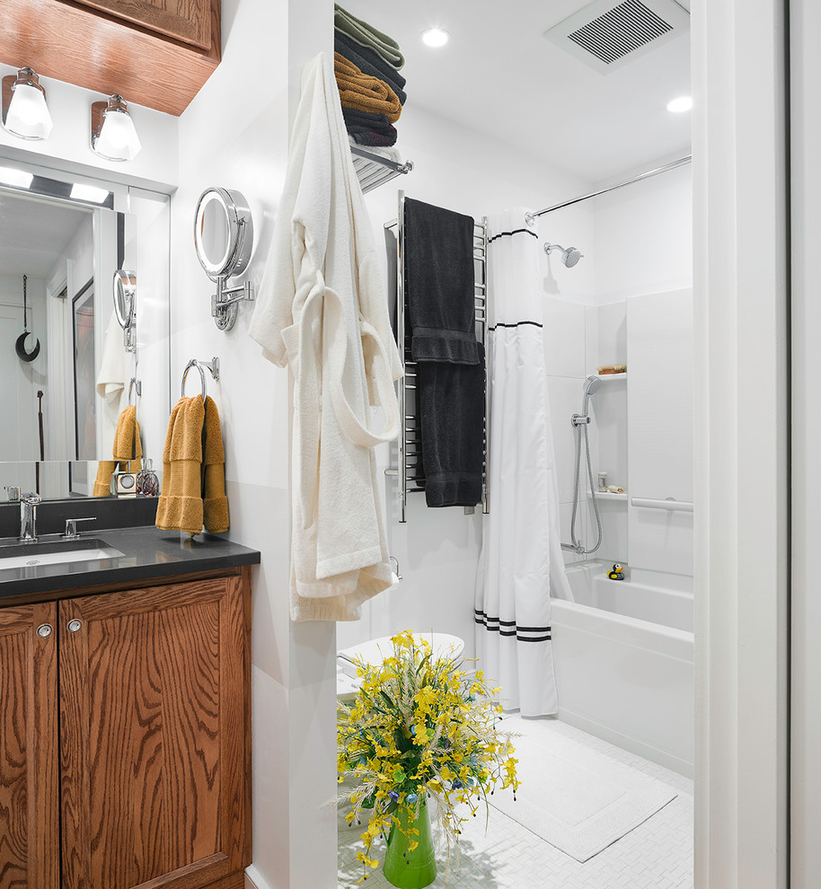 Photo of a mid-sized contemporary master bathroom in New York with medium wood cabinets, an alcove tub, a shower/bathtub combo, a one-piece toilet, white tile, white walls, an undermount sink, engineered quartz benchtops, shaker cabinets, white floor, a shower curtain, ceramic tile and laminate floors.