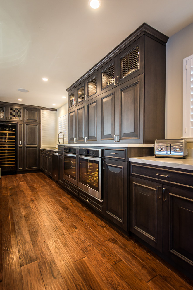 This is an example of a transitional kitchen in San Francisco with medium hardwood floors.