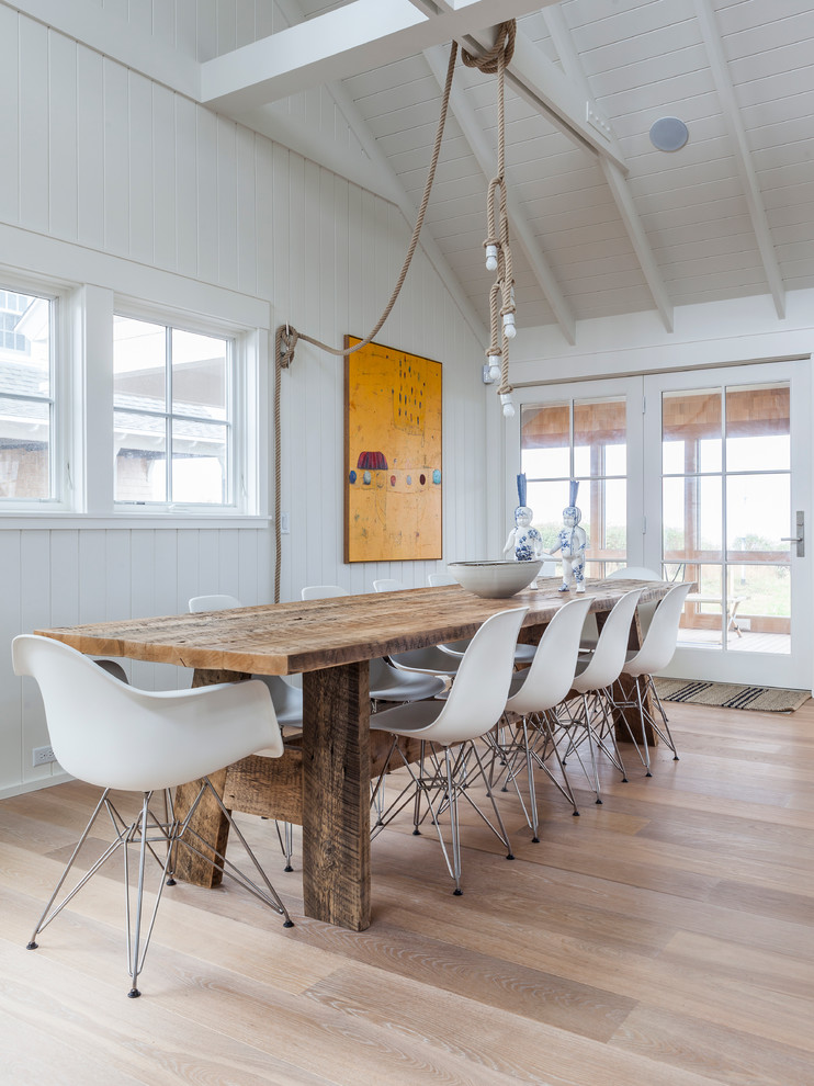 Photo of a beach style open plan dining in Boston with white walls.