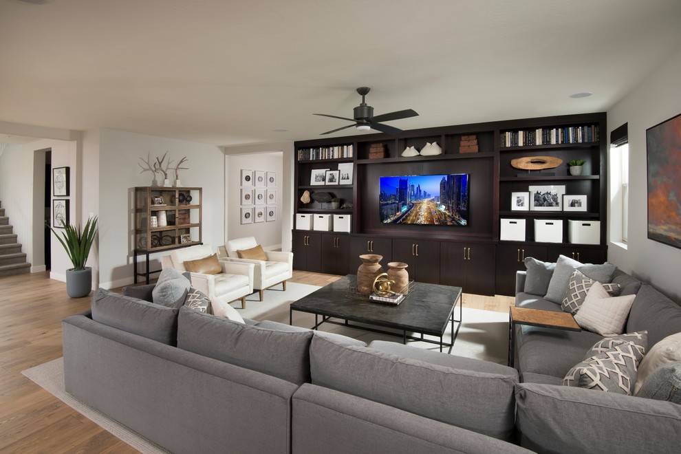 Contemporary open concept living room in Phoenix with white walls, medium hardwood floors, a built-in media wall and brown floor.