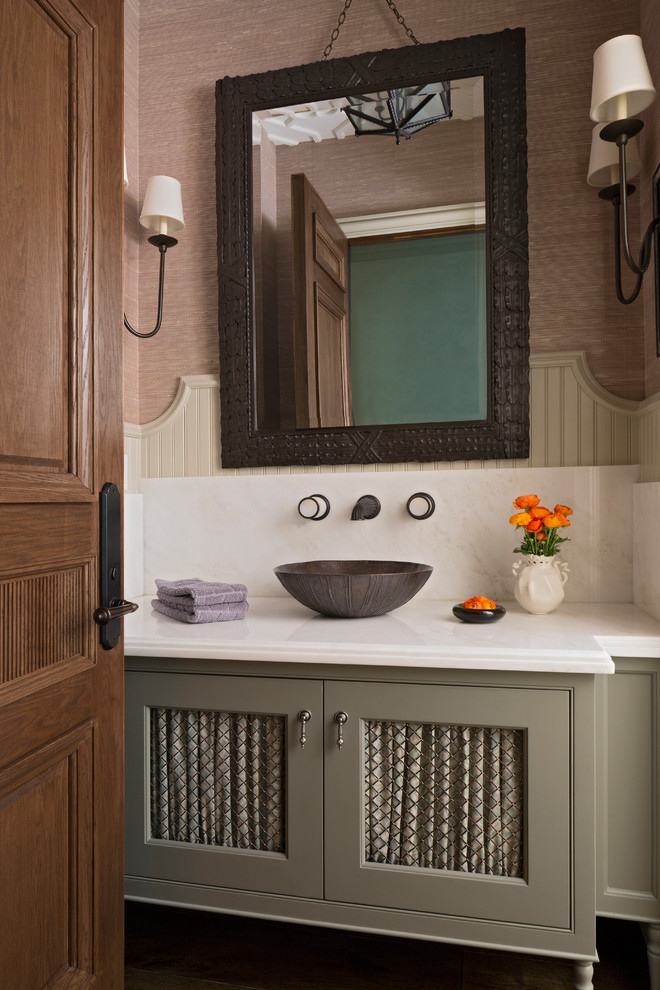 Photo of a traditional powder room in Los Angeles with furniture-like cabinets, grey cabinets, brown walls, a vessel sink and white benchtops.