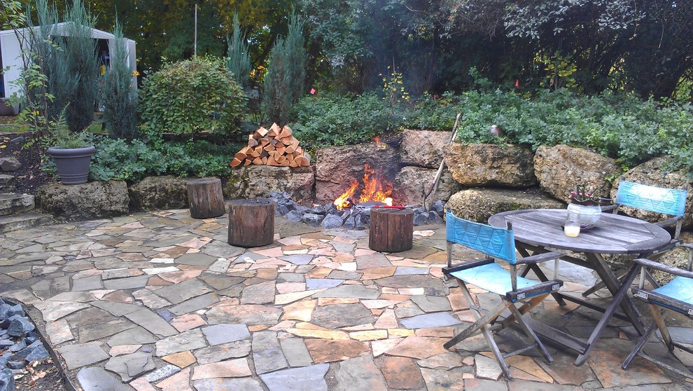 Inspiration for a mid-sized country backyard patio in Minneapolis with a fire feature, concrete pavers and no cover.
