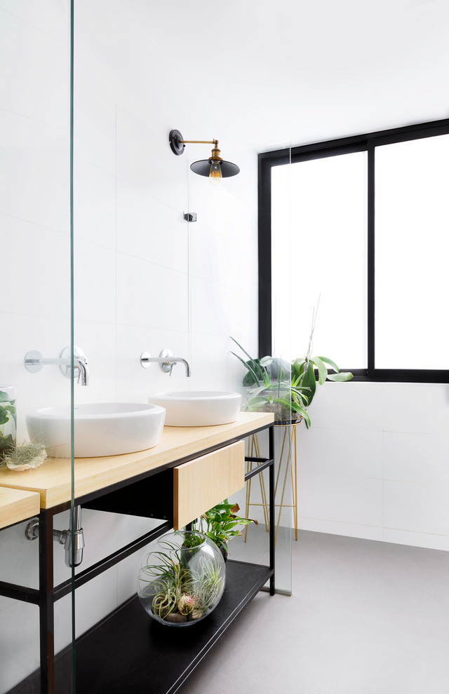 This is an example of a contemporary 3/4 bathroom in Sydney with light wood cabinets, white tile, white walls, a vessel sink, wood benchtops, grey floor, beige benchtops and flat-panel cabinets.