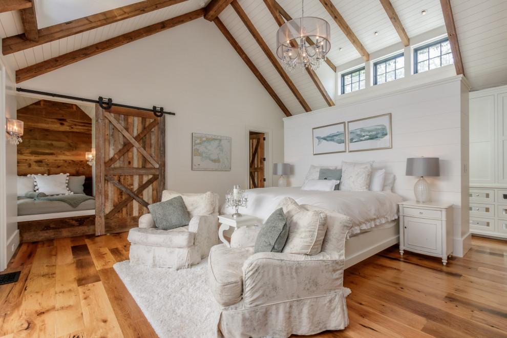 This is an example of a shabby-chic style guest bedroom in Boston with medium hardwood flooring, brown floors, a vaulted ceiling and tongue and groove walls.