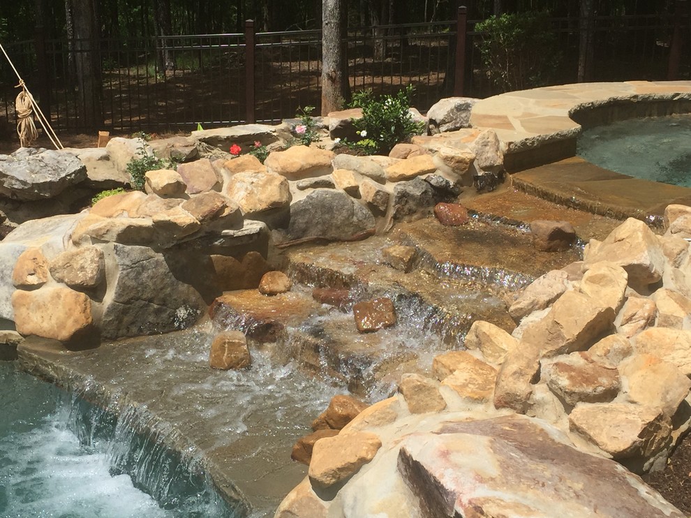 Hot tub - mid-sized rustic backyard stone and custom-shaped natural hot tub idea in Atlanta