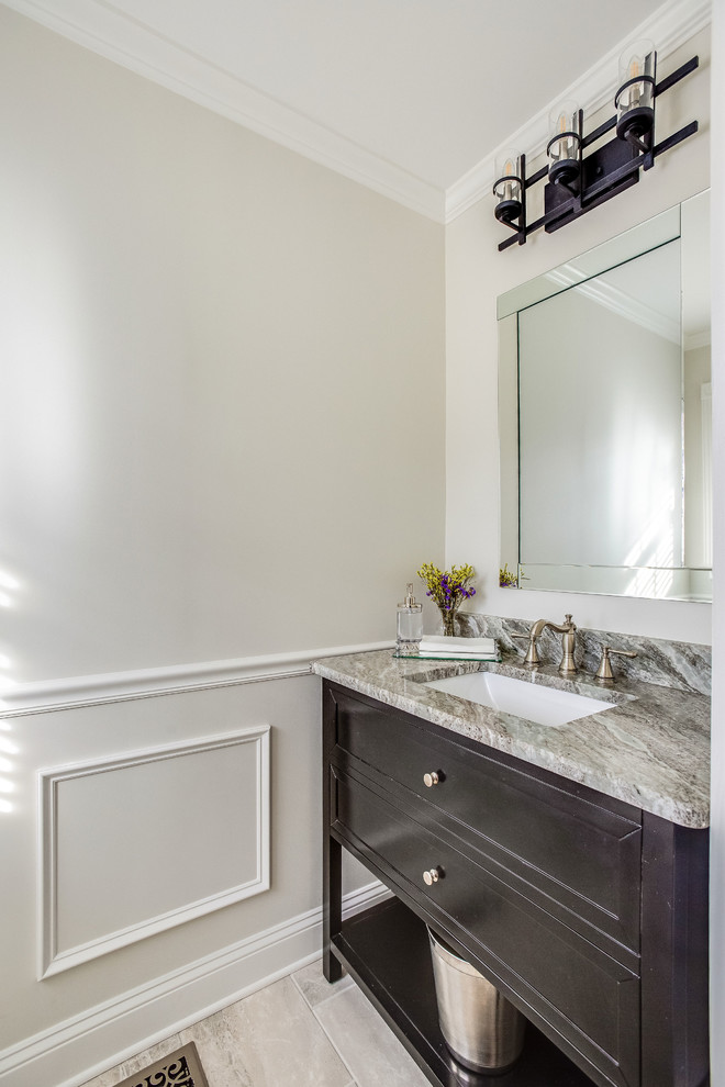 Inspiration for a small transitional powder room in Birmingham with recessed-panel cabinets, dark wood cabinets, a two-piece toilet, grey walls, porcelain floors, an undermount sink, marble benchtops, grey floor and multi-coloured benchtops.
