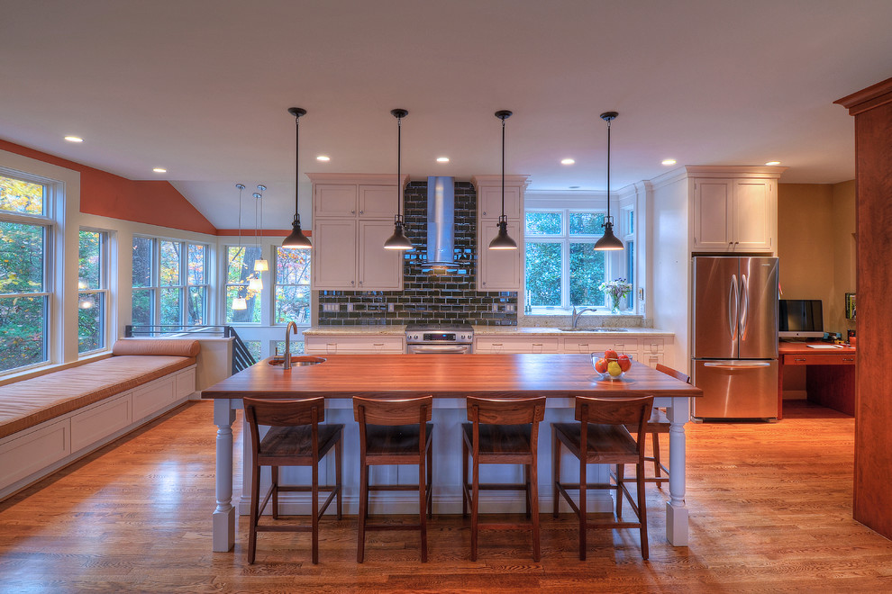 Open concept kitchen - large transitional medium tone wood floor open concept kitchen idea in DC Metro with an undermount sink, shaker cabinets, white cabinets, granite countertops, green backsplash, subway tile backsplash, stainless steel appliances and an island