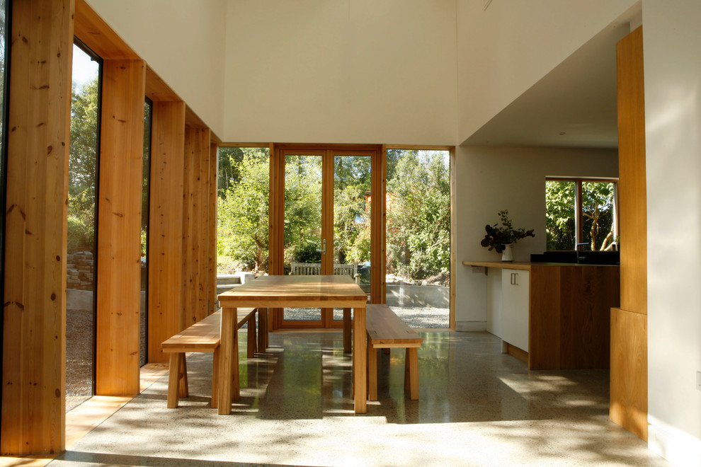 Photo of a contemporary dining room in Dublin with concrete floors.
