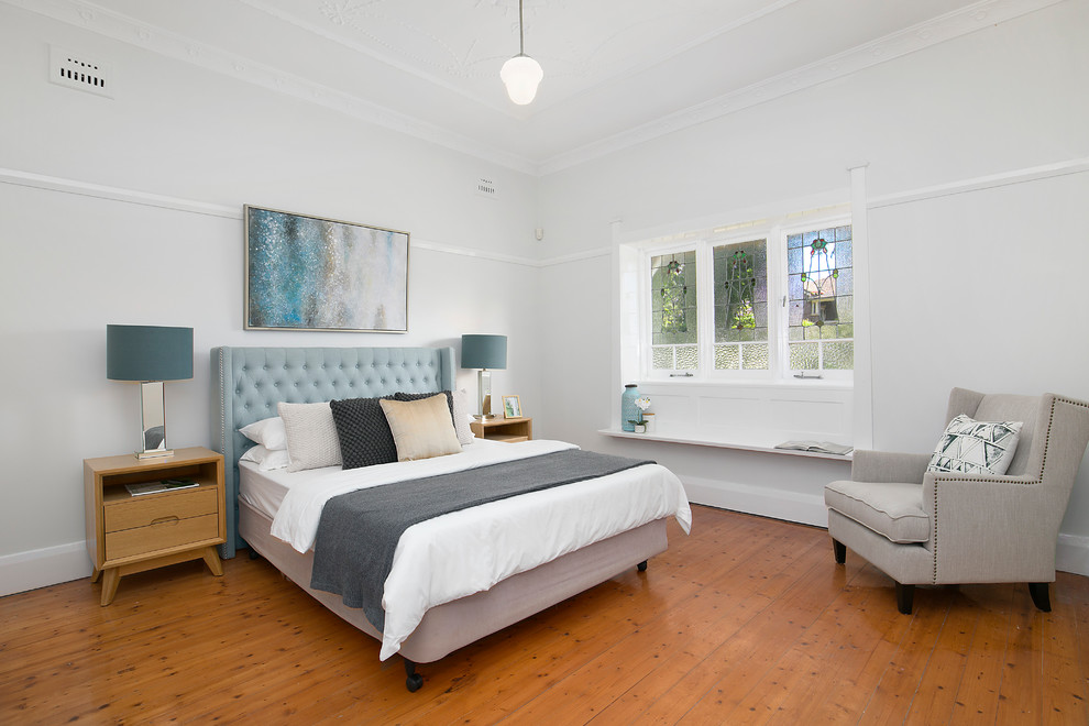 Inspiration for a large midcentury master bedroom in Sydney with white walls, medium hardwood floors, no fireplace and brown floor.