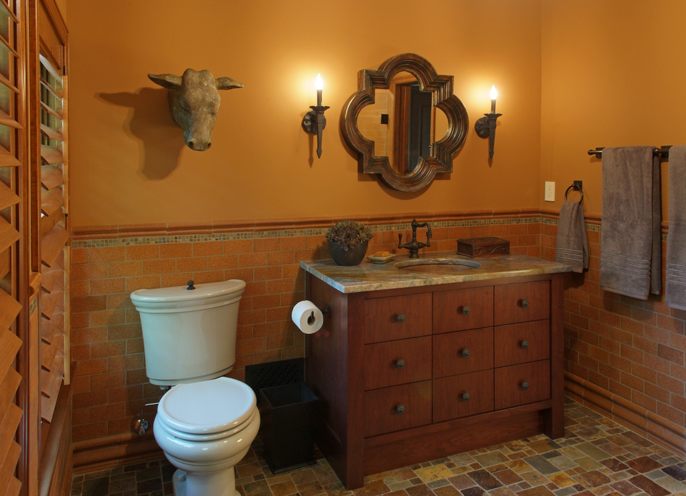 Photo of a mid-sized transitional 3/4 bathroom in Minneapolis with an undermount sink, furniture-like cabinets, medium wood cabinets, granite benchtops, a curbless shower, a two-piece toilet, brown tile, terra-cotta tile, yellow walls and porcelain floors.