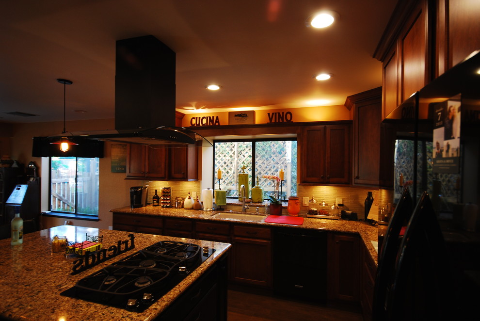Elegant u-shaped eat-in kitchen photo with an undermount sink, shaker cabinets, brown cabinets, quartz countertops, beige backsplash, glass sheet backsplash and black appliances
