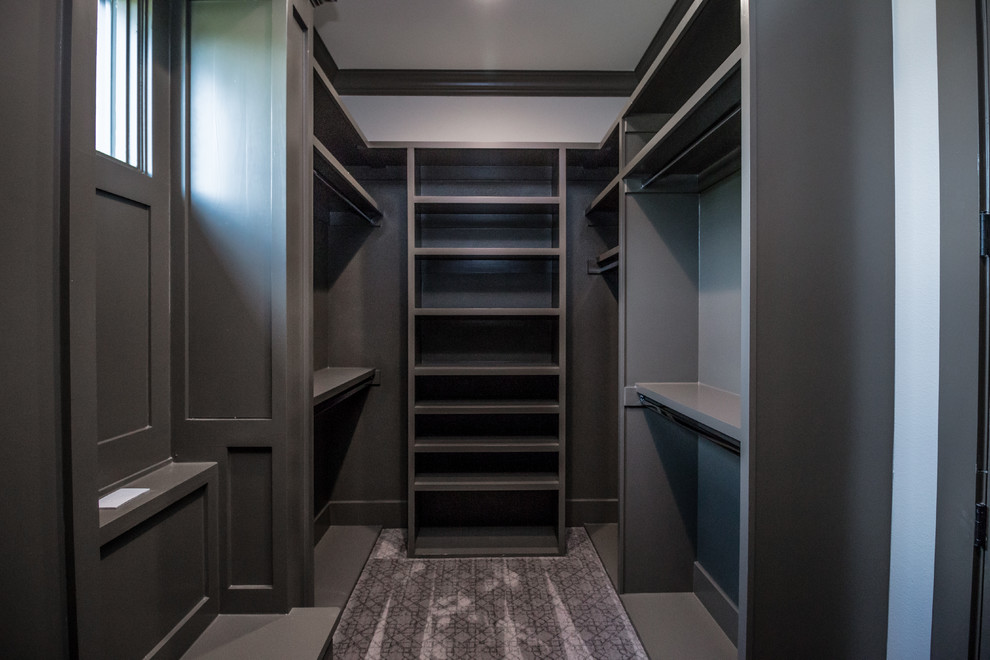 Photo of a large transitional gender-neutral walk-in wardrobe in Other with open cabinets, grey cabinets, carpet and grey floor.