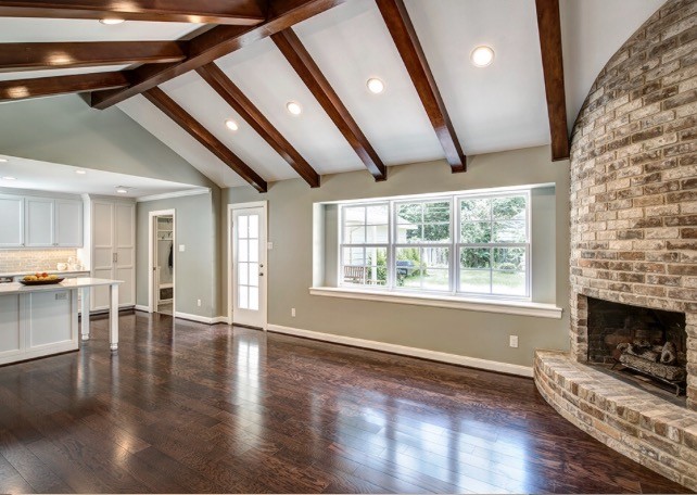 Mid-sized transitional open concept family room in Houston with grey walls, dark hardwood floors, a corner fireplace and a stone fireplace surround.