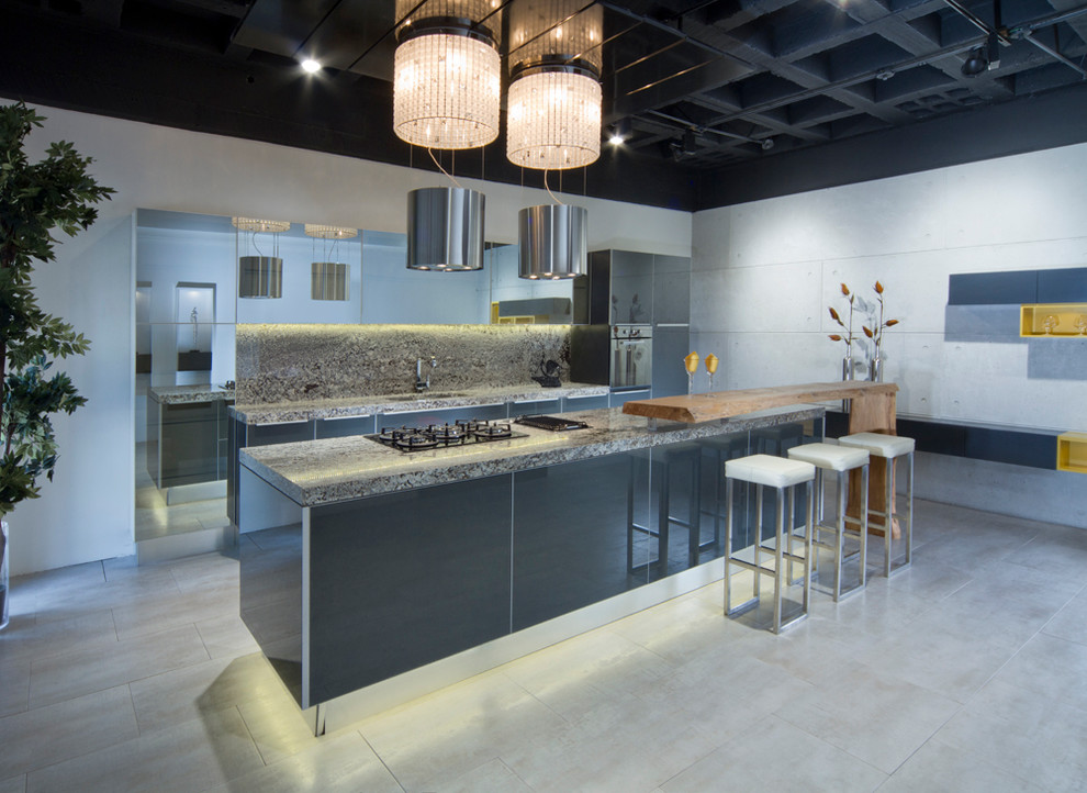 Photo of a mid-sized modern galley eat-in kitchen in Houston with glass-front cabinets, grey cabinets, an undermount sink, granite benchtops, grey splashback, stone slab splashback, stainless steel appliances, concrete floors and with island.