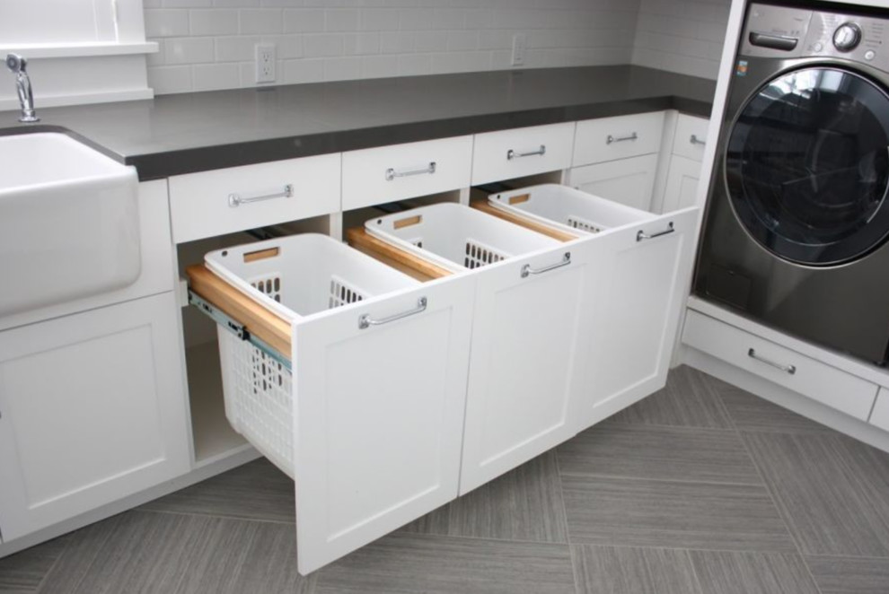 Photo of a mid-sized modern galley dedicated laundry room in Other with flat-panel cabinets and white cabinets.