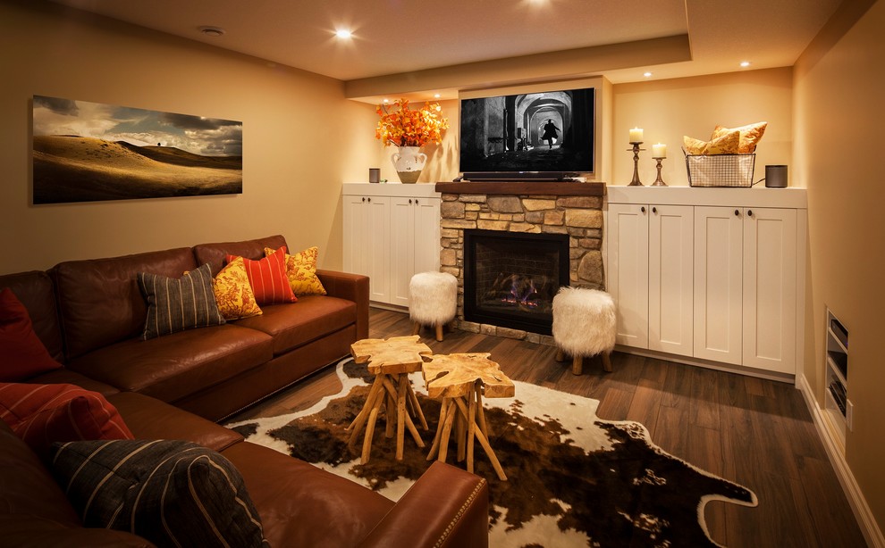 Example of a mid-sized transitional look-out brown floor and ceramic tile basement design in Calgary with yellow walls, a standard fireplace and a stone fireplace