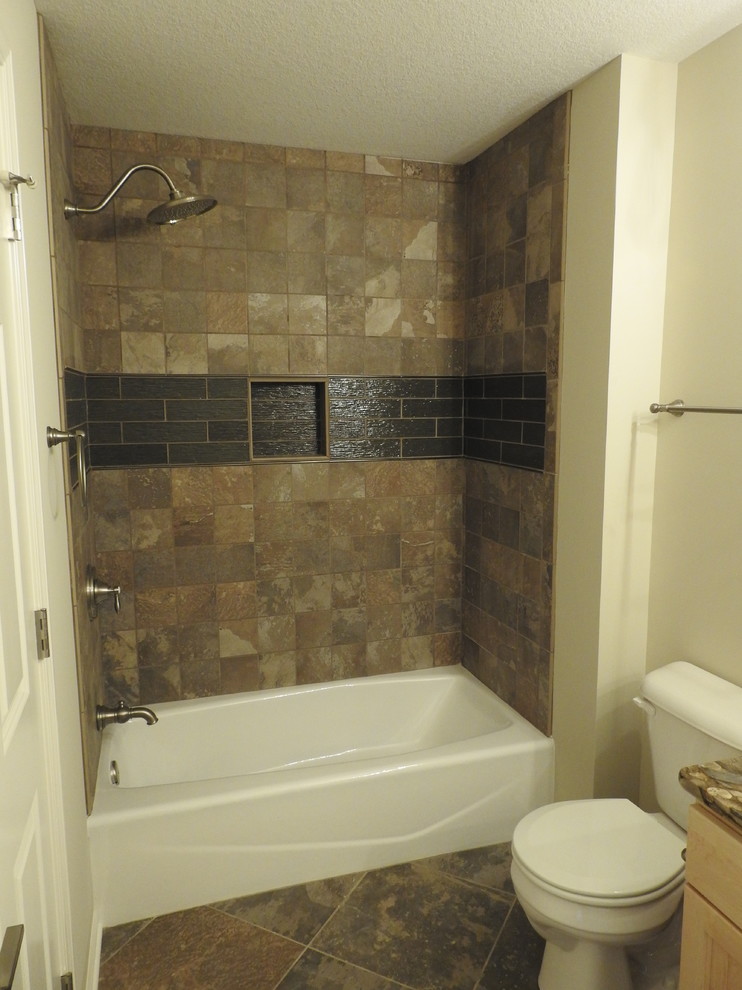Design ideas for a small country master bathroom in Other with flat-panel cabinets, light wood cabinets, an alcove tub, a shower/bathtub combo, a two-piece toilet, brown tile, ceramic tile, beige walls, ceramic floors, an integrated sink, granite benchtops, brown floor and a shower curtain.