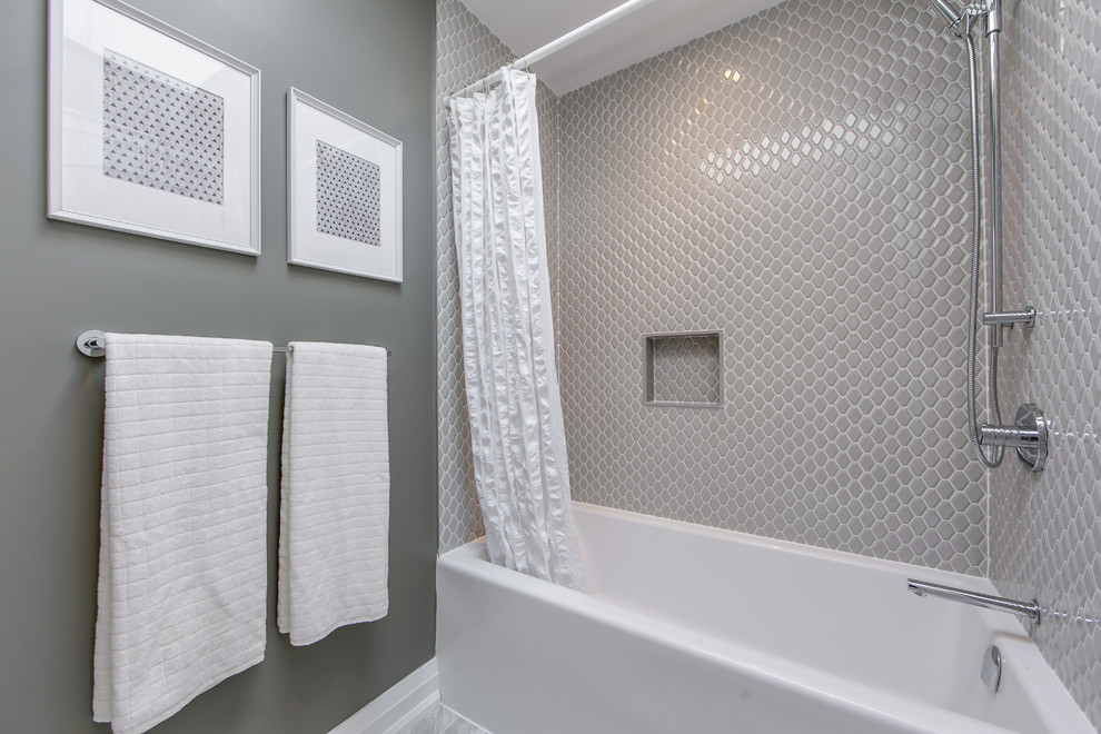 This is an example of a mid-sized contemporary kids bathroom in Toronto with flat-panel cabinets, white cabinets, a corner tub, a corner shower, a one-piece toilet, gray tile, stone tile, white walls, limestone floors, a drop-in sink, marble benchtops, grey floor, a shower curtain and white benchtops.