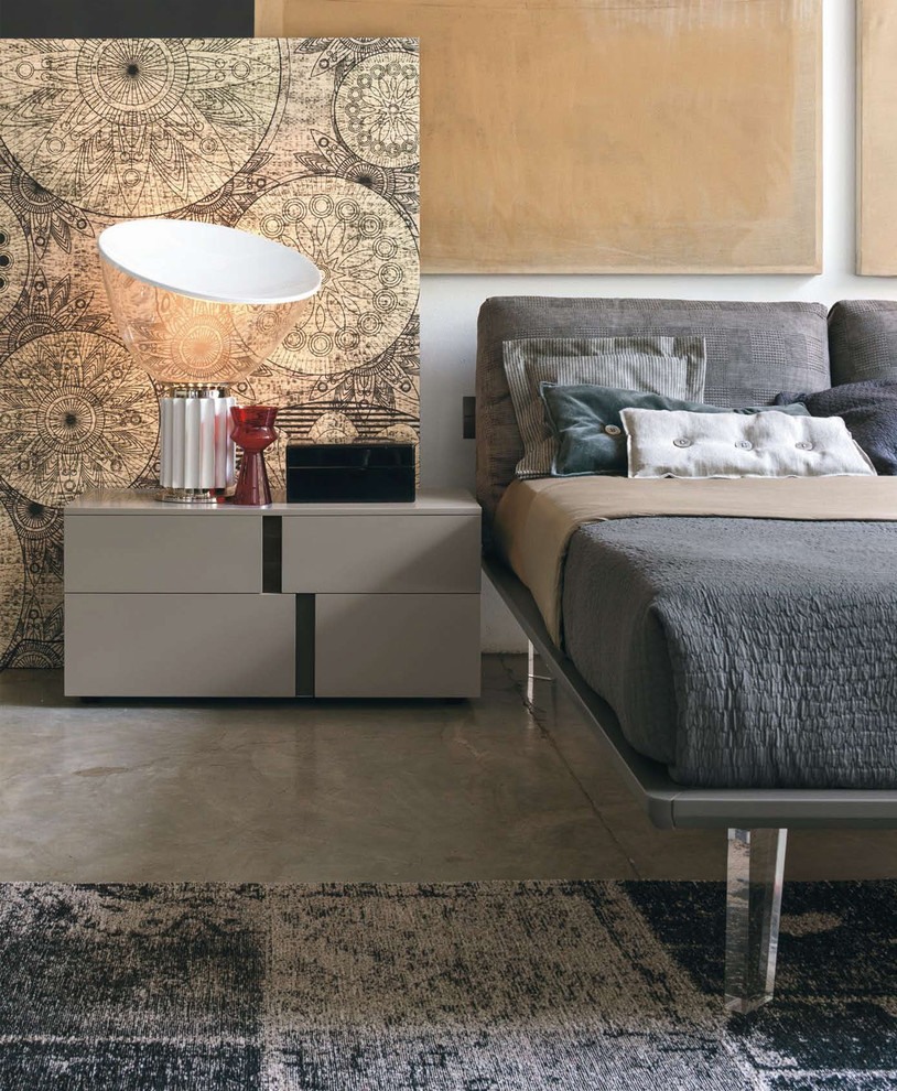 Photo of a mid-sized modern loft-style bedroom in Other with white walls, concrete floors and grey floor.