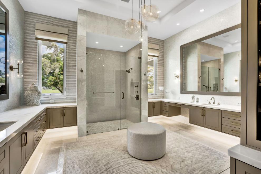 This is an example of a mid-sized contemporary kids bathroom in Miami with furniture-like cabinets, grey cabinets, an alcove shower, a one-piece toilet, blue tile, marble, white walls, marble floors, an undermount sink, marble benchtops, beige floor, a hinged shower door, blue benchtops, a niche, a double vanity, a built-in vanity, recessed and wallpaper.