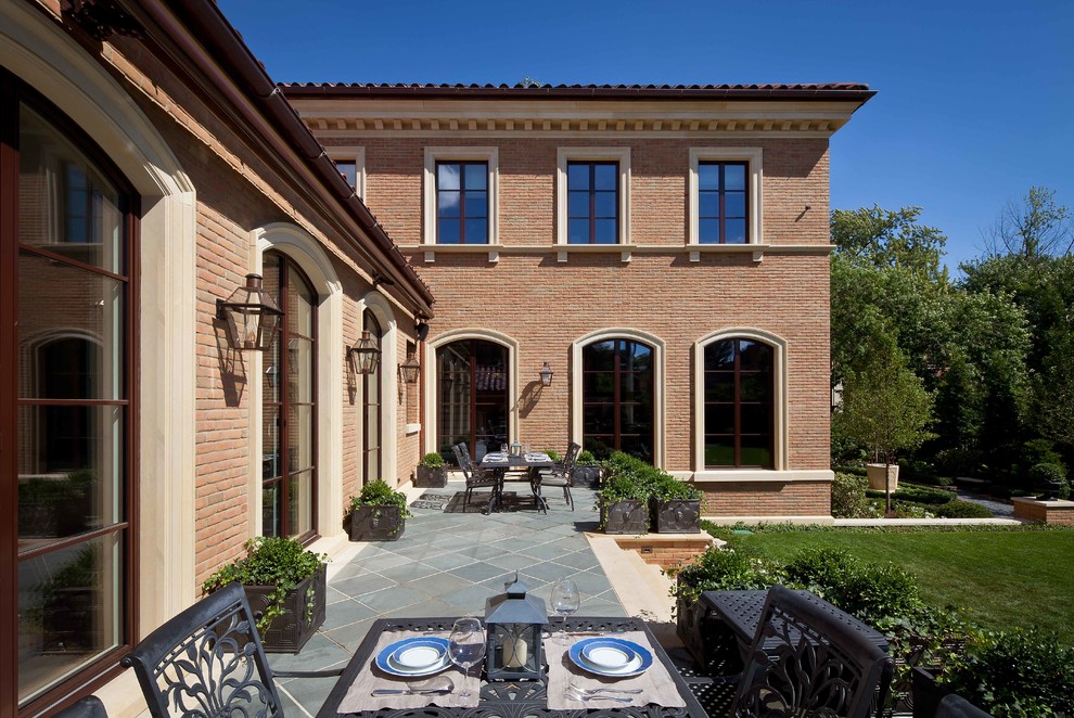 Inspiration for an expansive traditional two-storey brick exterior in Chicago with a hip roof.