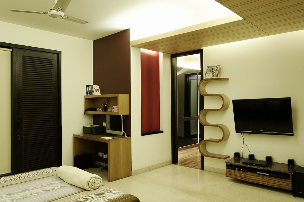 Inspiration for a mid-sized contemporary master bedroom in Delhi with marble floors, no fireplace and beige walls.