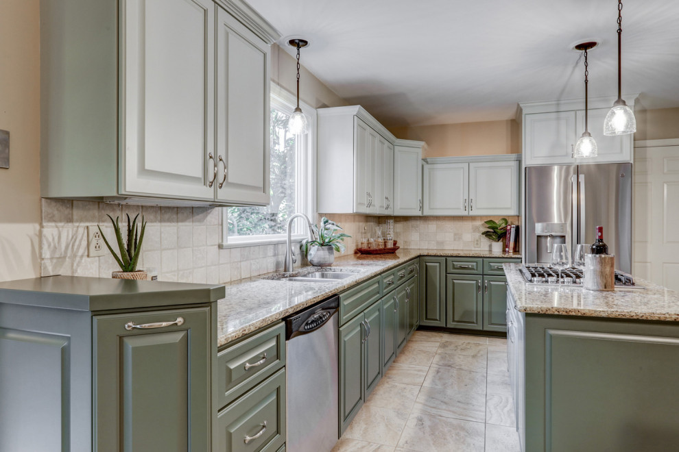 Eat-in kitchen - mid-sized transitional l-shaped ceramic tile and beige floor eat-in kitchen idea with a double-bowl sink, raised-panel cabinets, green cabinets, granite countertops, beige backsplash, ceramic backsplash, stainless steel appliances, an island and beige countertops