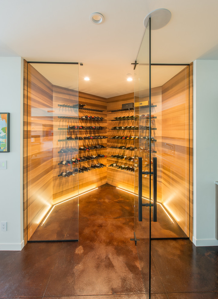 This is an example of a large contemporary wine cellar in Seattle with storage racks, brown floor and concrete floors.