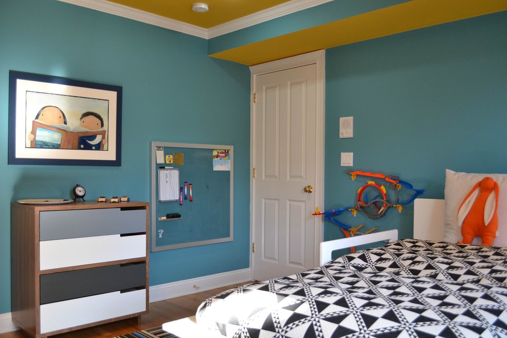 Design ideas for a mid-sized contemporary kids' bedroom for kids 4-10 years old and boys in Boston with blue walls and light hardwood floors.