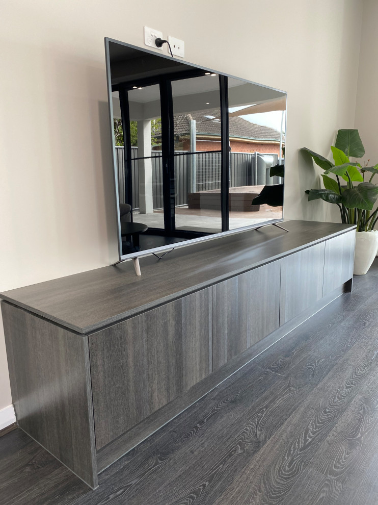 Design ideas for a contemporary open concept living room in Adelaide with white walls, laminate floors and grey floor.