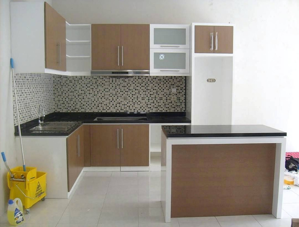 Example of a mid-sized trendy galley white floor kitchen design with a single-bowl sink, flat-panel cabinets, yellow cabinets, granite countertops and black countertops