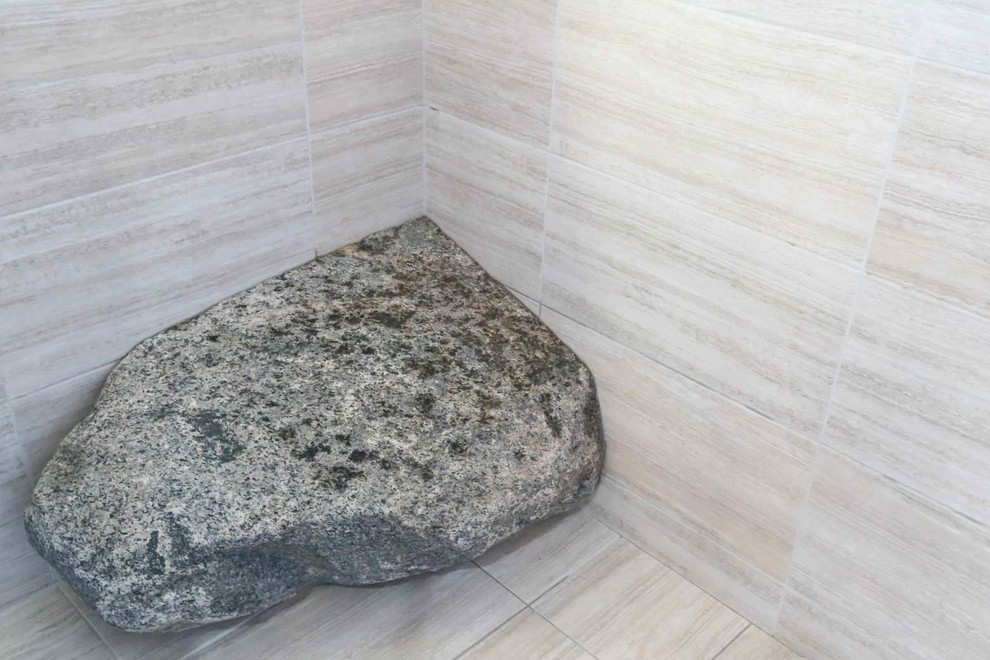 Example of a large transitional master beige tile and porcelain tile porcelain tile and beige floor freestanding bathtub design with shaker cabinets, black cabinets, a two-piece toilet, beige walls, a vessel sink, quartzite countertops, a hinged shower door and black countertops