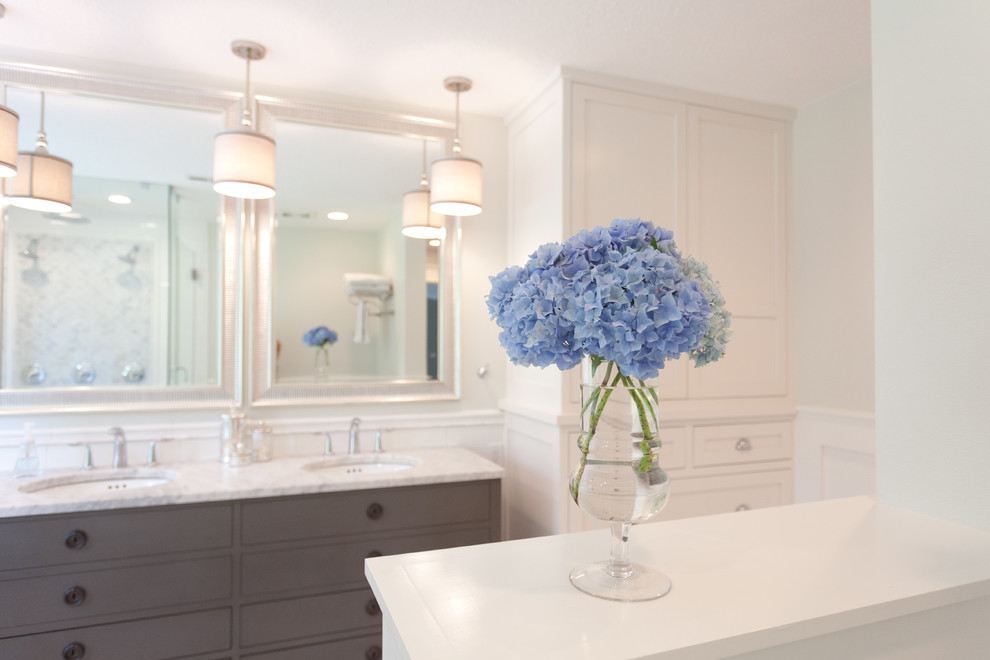 Design ideas for a mid-sized transitional master bathroom in Portland with an undermount sink, furniture-like cabinets, grey cabinets, marble benchtops, a freestanding tub, a corner shower, a one-piece toilet, white tile, subway tile, white walls and marble floors.