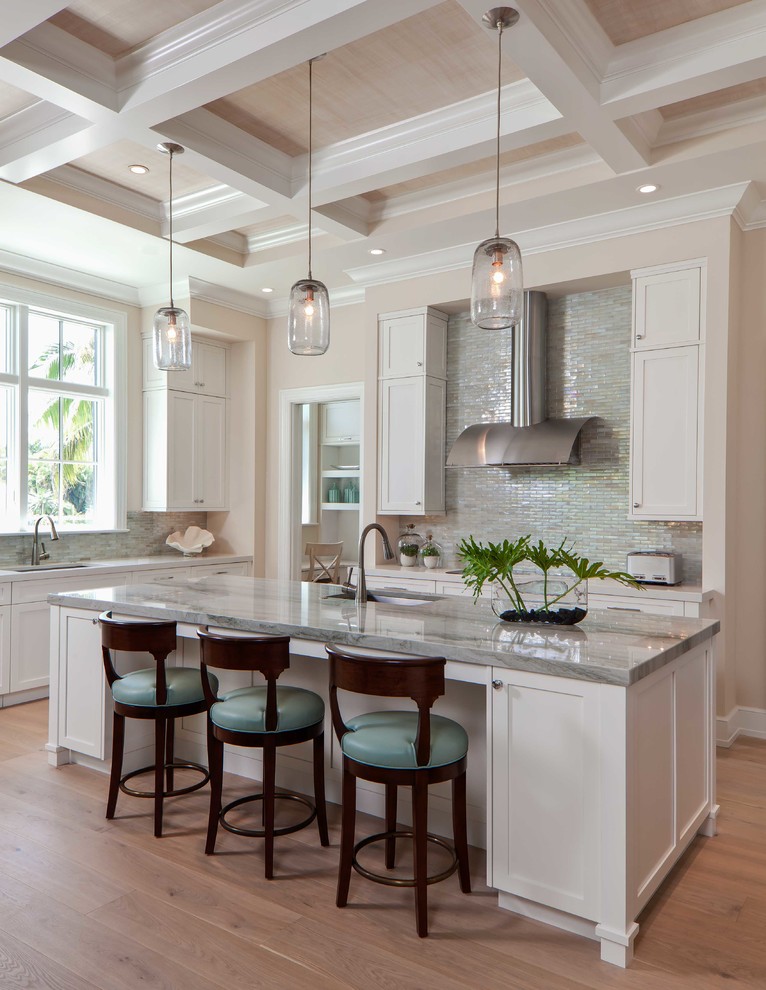Inspiration for a large transitional galley light wood floor eat-in kitchen remodel in Miami with an undermount sink, flat-panel cabinets, beige cabinets, quartzite countertops, gray backsplash, glass tile backsplash, stainless steel appliances and an island