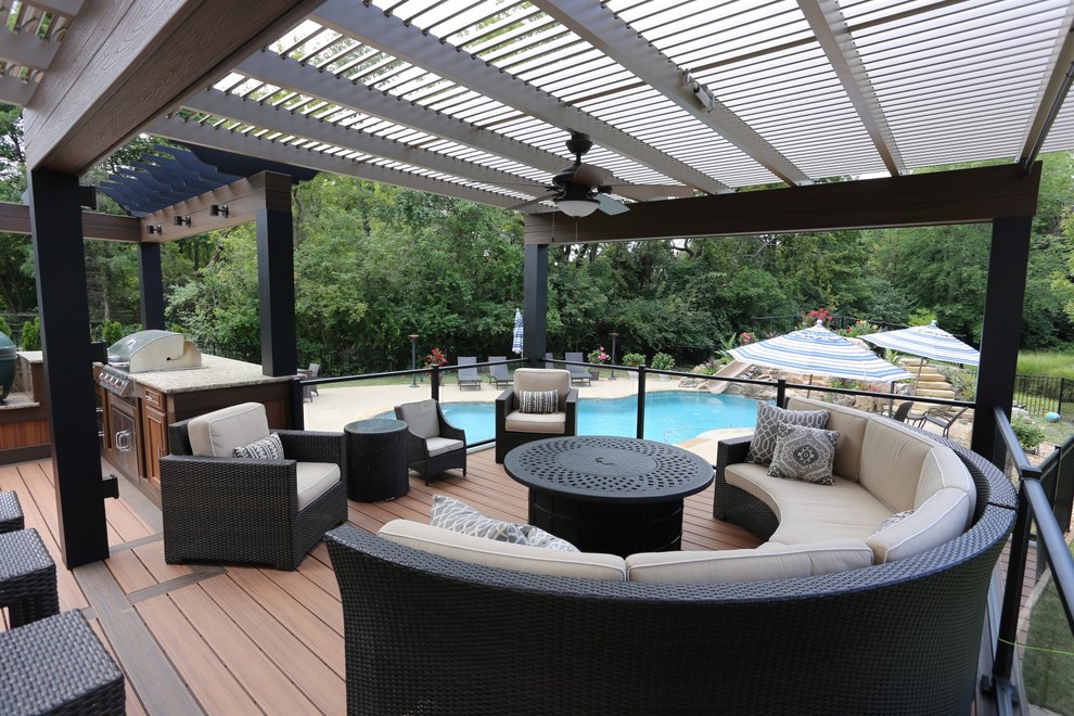 Photo of a large contemporary backyard deck in St Louis with a pergola.