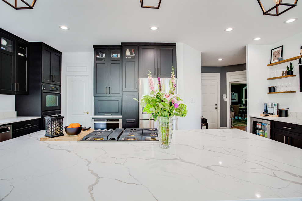 Inspiration for a large transitional u-shaped eat-in kitchen remodel in DC Metro with a farmhouse sink, quartz countertops, stainless steel appliances and an island