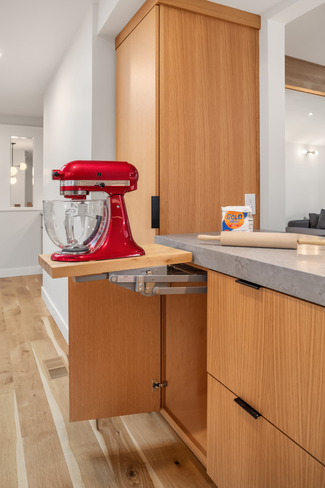Eat-in kitchen - mid-sized transitional light wood floor eat-in kitchen idea in Seattle with an undermount sink, flat-panel cabinets, light wood cabinets, quartz countertops, green backsplash, ceramic backsplash, stainless steel appliances, an island and gray countertops