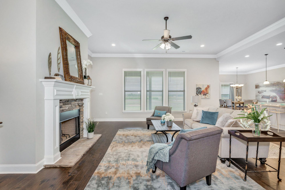 Mid-sized traditional open concept living room in Other with grey walls, dark hardwood floors, a standard fireplace, a brick fireplace surround, brown floor and vaulted.