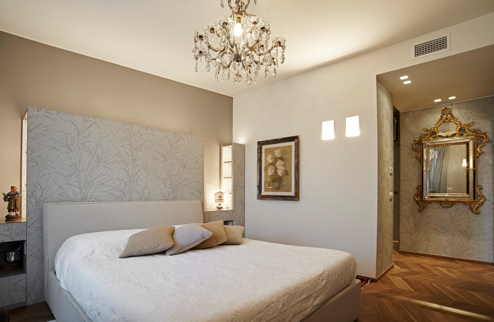 This is an example of a mid-sized transitional master bedroom in Milan with beige walls, medium hardwood floors and brown floor.
