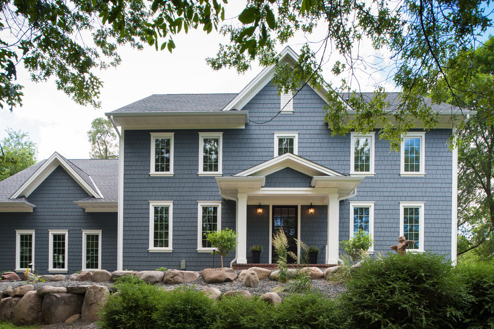Design ideas for a large traditional two-storey blue house exterior in Minneapolis.