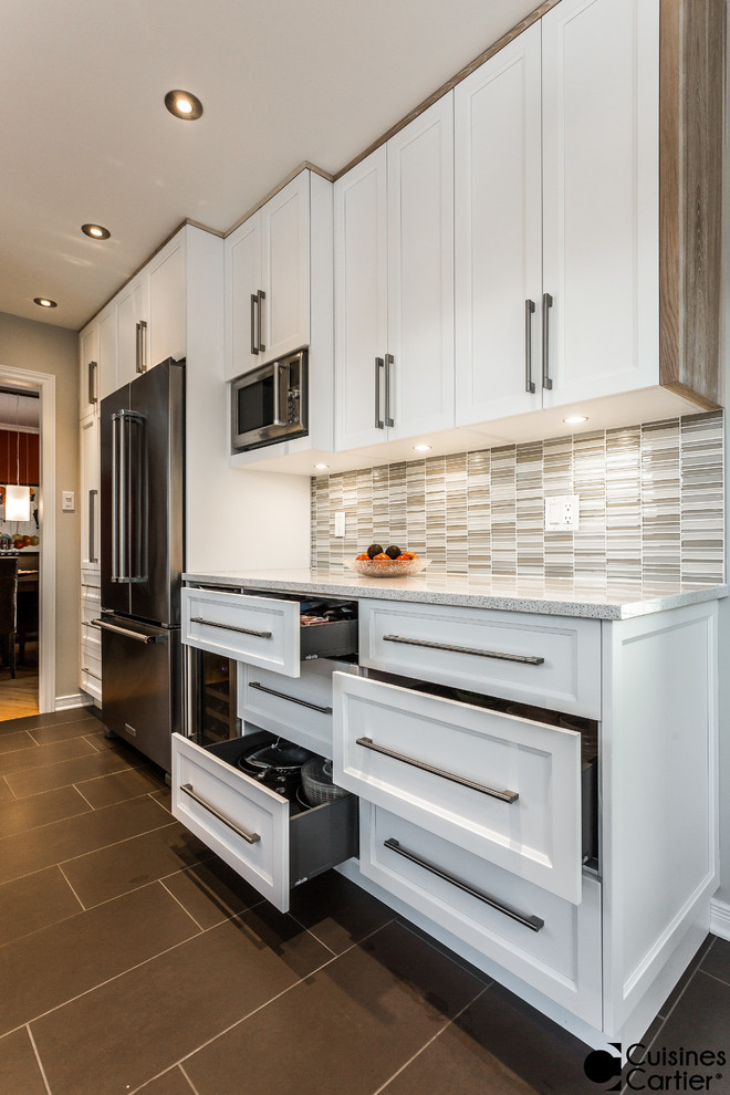 Small scandinavian galley separate kitchen in Montreal with an undermount sink, shaker cabinets, white cabinets, quartzite benchtops, grey splashback, glass tile splashback, stainless steel appliances, ceramic floors and no island.