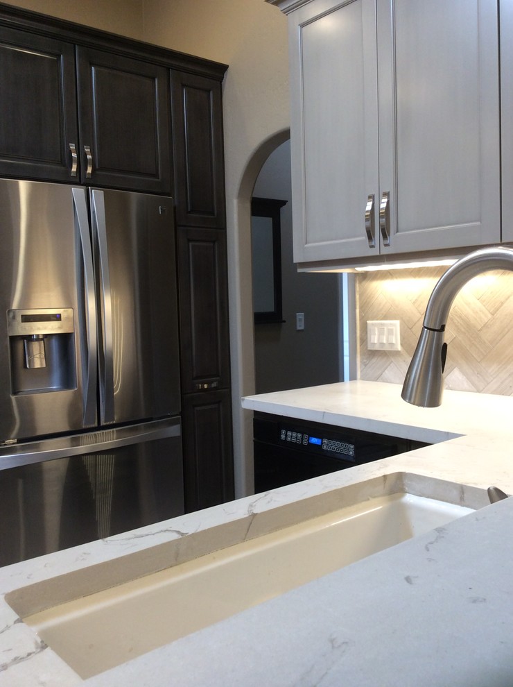 Eat-in kitchen - mid-sized transitional dark wood floor and brown floor eat-in kitchen idea in Phoenix with a single-bowl sink, raised-panel cabinets, dark wood cabinets, onyx countertops, brown backsplash, ceramic backsplash, stainless steel appliances and an island