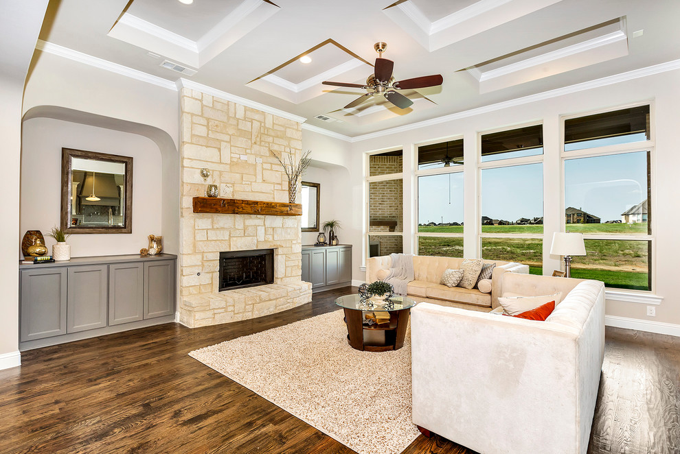 Mid-sized contemporary open concept family room in Dallas with dark hardwood floors, a standard fireplace, a stone fireplace surround, a wall-mounted tv, grey walls and brown floor.