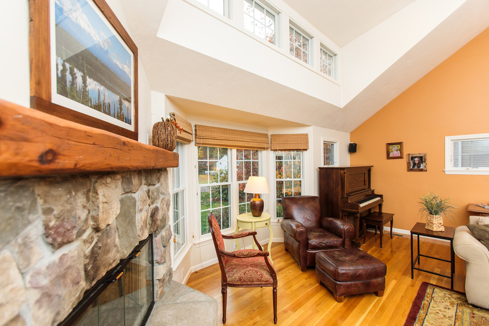 Photo of a large traditional loft-style family room in Boston with a music area, yellow walls, medium hardwood floors, a corner fireplace, a stone fireplace surround and a freestanding tv.