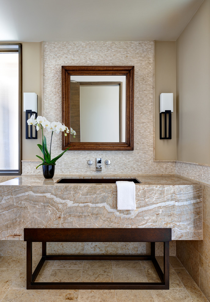 Large transitional powder room in Phoenix with beige cabinets, a one-piece toilet, multi-coloured tile, ceramic tile, beige walls, limestone floors, an undermount sink, granite benchtops, beige floor and beige benchtops.
